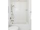 Bathroom featuring a white tub, white subway tiles, and modern fixtures at 1750 Wewatta St # 740, Denver, CO 80202