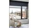 Bedroom chair by a large window showing city and distant building views at 1750 Wewatta St # 740, Denver, CO 80202