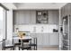 Modern kitchen features grey cabinets, a stainless steel fridge, and a cozy breakfast nook at 1750 Wewatta St # 740, Denver, CO 80202