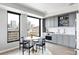 Stylish eat-in kitchen boasts stainless appliances, modern grey cabinets, and fantastic city views at 1750 Wewatta St # 740, Denver, CO 80202