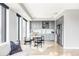 Bright, modern kitchen features grey cabinets, stainless steel appliances, and a cozy dining nook at 1750 Wewatta St # 740, Denver, CO 80202