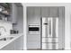 Well-appointed kitchen features stainless steel appliances and modern grey cabinets at 1750 Wewatta St # 740, Denver, CO 80202