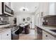 Bright kitchen with stainless steel appliances and granite countertops and modern fixtures at 15123 E Wesley Ave, Aurora, CO 80014