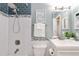 Updated bathroom featuring a shower with white subway tile and blue accent tile, plus a modern vanity with a framed print at 2645 S Xanadu Way # D, Aurora, CO 80014