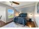 Inviting bedroom with a slanted ceiling, plush bed, nautical-themed decor, and scenic views from the window at 2645 S Xanadu Way # D, Aurora, CO 80014
