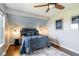 Charming bedroom with a unique slanted ceiling, adorned with a plush bed, sconces, and nautical-themed art at 2645 S Xanadu Way # D, Aurora, CO 80014