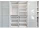 Organized closet space featuring adjustable shelving, wire baskets, and sleek glass door panels for efficient storage at 2645 S Xanadu Way # D, Aurora, CO 80014