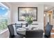 Cozy dining area with wainscoting, a round table set for four, and a large window with scenic views at 2645 S Xanadu Way # D, Aurora, CO 80014
