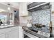 Bright modern kitchen with stainless steel appliances and a designer backsplash at 2645 S Xanadu Way # D, Aurora, CO 80014