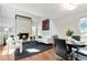 Open-concept living room with a cozy fireplace, sleek hardwood floors, and contemporary furnishings at 2645 S Xanadu Way # D, Aurora, CO 80014