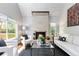 Cozy living room with stone fireplace, hardwood floors, and ample natural light at 2645 S Xanadu Way # D, Aurora, CO 80014