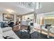 Spacious living room features hardwood floors, a modern kitchen view, and an open floor plan at 2645 S Xanadu Way # D, Aurora, CO 80014