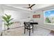 Bright home office with vaulted ceilings, a ceiling fan, large windows, and designer rug offering a stylish workspace at 2645 S Xanadu Way # D, Aurora, CO 80014