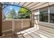 Relaxing covered patio with outdoor lighting and a privacy fence, perfect for enjoying the outdoors in comfort and style at 2645 S Xanadu Way # D, Aurora, CO 80014