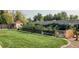 Backyard featuring a neat lawn, mature trees, garden beds, shed, and fenced border at 7600 Kline Dr, Arvada, CO 80005
