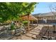 Captivating backyard featuring a rock water feature, wood pergola, stone pathway, mature trees and manicured shrubbery at 7600 Kline Dr, Arvada, CO 80005
