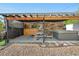 Outdoor patio features a hot tub, dining set, and rustic wooden decor, perfect for relaxing at 7600 Kline Dr, Arvada, CO 80005