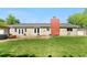 Spacious backyard with a well-maintained lawn and access to the back of the house and patio at 7600 Kline Dr, Arvada, CO 80005