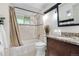 Cozy bathroom featuring a shower-tub combo and a dark vanity with a granite countertop at 7600 Kline Dr, Arvada, CO 80005