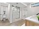 Bright bathroom featuring a modern shower, stylish vanity, and contemporary fixtures at 7600 Kline Dr, Arvada, CO 80005
