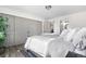 Primary bedroom with luxury vinyl plank flooring, and an en-suite bathroom and large closet at 7600 Kline Dr, Arvada, CO 80005