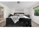 Bright bedroom featuring luxury vinyl plank flooring, a bed, bedside tables, and bright natural light at 7600 Kline Dr, Arvada, CO 80005