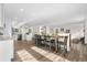 Bright dining room with hardwood floors flowing into an open kitchen featuring stainless steel appliances at 7600 Kline Dr, Arvada, CO 80005