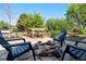 Cozy outdoor fire pit area with Adirondack chairs and water feature, creating a relaxing entertainment space at 7600 Kline Dr, Arvada, CO 80005