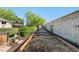 Established garden area with raised beds and lush greenery surrounded by fencing and stone walls at 7600 Kline Dr, Arvada, CO 80005