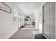 Bright and airy hallway with neutral tile, multiple windows, and natural light streaming in from a back door at 7600 Kline Dr, Arvada, CO 80005