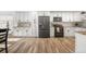 Modern kitchen showcasing stainless steel appliances, white cabinetry, granite countertops, and wood-style flooring at 7600 Kline Dr, Arvada, CO 80005