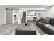 Spacious living room featuring modern finishes, comfortable seating, and a stylish workspace with natural light at 7600 Kline Dr, Arvada, CO 80005