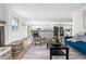 Bright, open living space with a fireplace and bar that connects to the kitchen area with stainless steel appliances at 7600 Kline Dr, Arvada, CO 80005