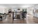 Inviting living space featuring a cozy fireplace, adjacent dining area, and hardwood floors at 7600 Kline Dr, Arvada, CO 80005