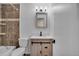 Modern bathroom featuring updated fixtures, sleek vanity with storage, and a tiled shower with glass door at 15650 E Eldorado Dr, Aurora, CO 80013