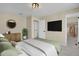 Comfortable bedroom features a stylish dresser, closet access, and mounted TV for easy viewing and relaxation at 15650 E Eldorado Dr, Aurora, CO 80013