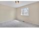 A bright bedroom with a large window and neutral walls and carpet at 15650 E Eldorado Dr, Aurora, CO 80013