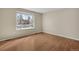Bedroom with hardwood floors, a large window, and neutral paint at 15650 E Eldorado Dr, Aurora, CO 80013