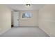 A carpeted bedroom with neutral walls and wainscoting, and a bright window at 15650 E Eldorado Dr, Aurora, CO 80013