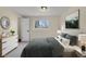 A furnished bedroom with neutral walls, a window, a dresser, and a bed at 15650 E Eldorado Dr, Aurora, CO 80013