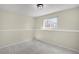 A cozy bedroom with wainscoting, neutral walls, a window, and soft carpet at 15650 E Eldorado Dr, Aurora, CO 80013