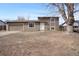 Split level home with a 2-car garage and muted brown siding under a blue sky at 15650 E Eldorado Dr, Aurora, CO 80013