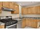 View of the kitchen with stainless steel appliances and stone countertops at 15650 E Eldorado Dr, Aurora, CO 80013