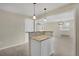 A kitchen island with granite countertops connects to the dining room with modern light fixtures at 15650 E Eldorado Dr, Aurora, CO 80013