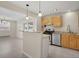 Eat-in kitchen featuring stainless steel appliances and light wood cabinetry at 15650 E Eldorado Dr, Aurora, CO 80013