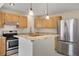 Charming kitchen with stainless steel appliances, granite countertops and light wood cabinets at 15650 E Eldorado Dr, Aurora, CO 80013