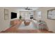 Bright living room features a stone fireplace, modern furnishings, and hardwood floors at 15650 E Eldorado Dr, Aurora, CO 80013