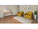 Cozy staged living room with two yellow armchairs and matching decor at 15650 E Eldorado Dr, Aurora, CO 80013