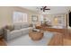Bright living room features hardwood floors, modern ceiling fan, and an adjacent dining area with sliding glass doors at 15650 E Eldorado Dr, Aurora, CO 80013
