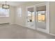 Bright living room featuring sliding glass doors and a modern chandelier at 15650 E Eldorado Dr, Aurora, CO 80013